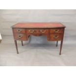 An Edwardian inlaid mahogany bow fronted five drawer kneehole desk with inset faux leather top,