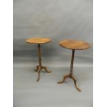A pair of antique elm occasional tables, raised on turned columns and tripod supports with pad feet,