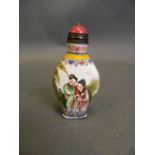 A Cantonese enamel snuff bottle with painted decoration of women in a garden, 4 character mark to