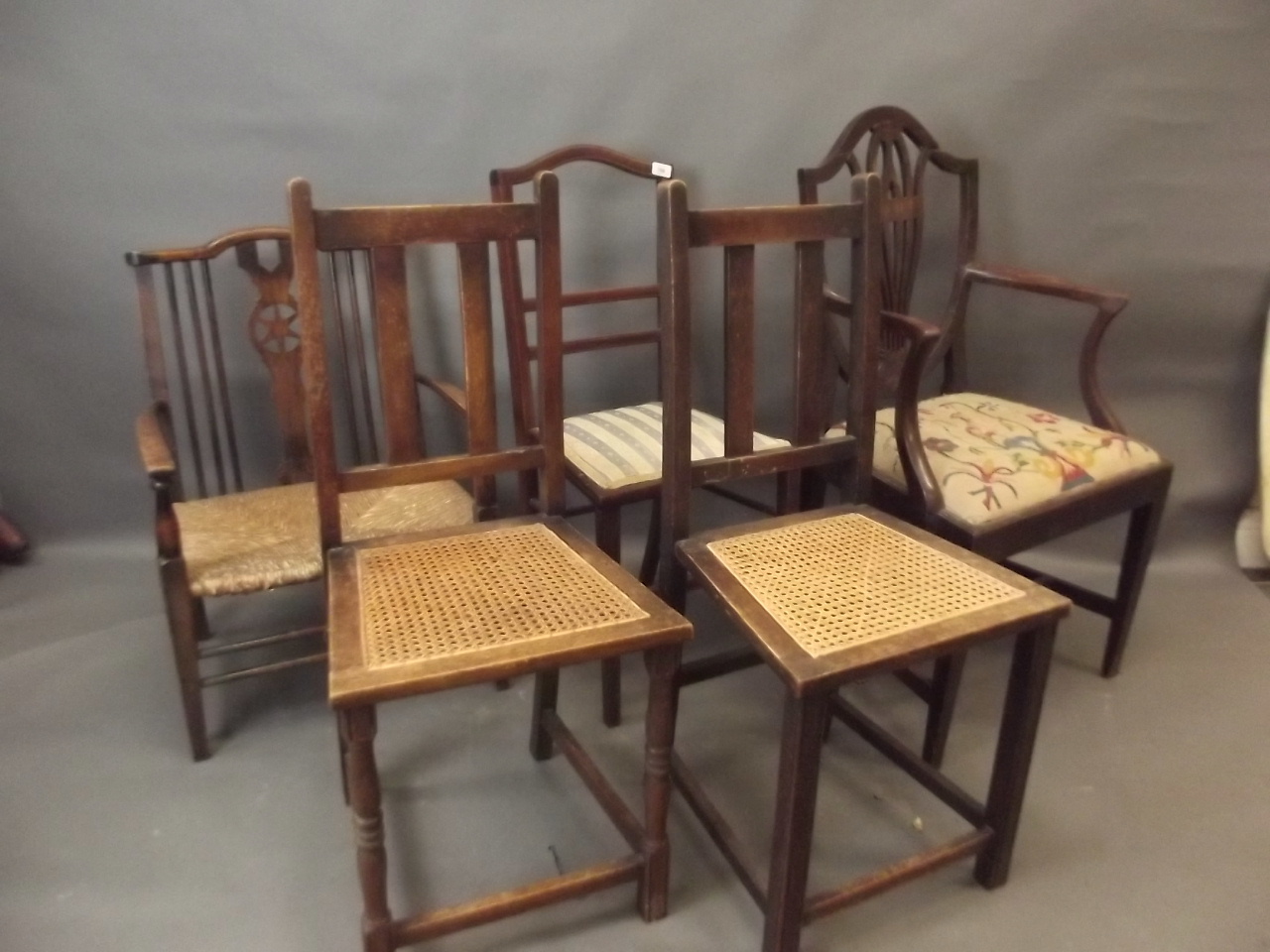 A C19th shield back elbow chair, a rush seated low elbow chair, and three others