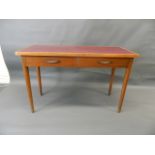 A mid C20th two drawer writing table with inset top, raised on turned tapering supports, 21" x 48" x