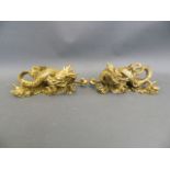 A pair of Chinese gilt metal scroll weights in the form of dragons, 7½" long