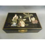 A Japanese lacquer jewellery box, the lid with applied hardstone decoration of geishas in a