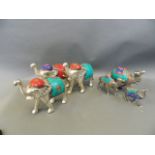 A collection of Middle Eastern mixed metal figure groups, comprising a caravan of camels, and