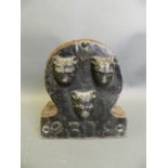 A C19th British painted lead fire insurance plaque decorated with three leopard masks, policy no.