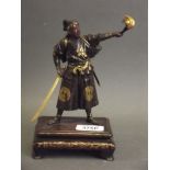 A fine Japanese Meiji period Miyao bronze figure of a samurai bearing a flaming torch, with gilt