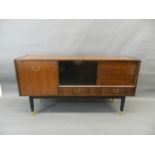 A 1960s Gomme mahogany sideboard with sliding doors over two drawers and a fall front cupboards,