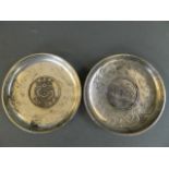 Two Chinese white metal coin dishes decorated with dragons and bats, 3½" diameter
