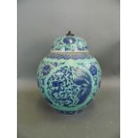 A Chinese blue ground jar and cover with stylised dragon, phoenix and lotus flower decoration in the