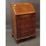 A serpentine shaped walnut fall front bureau, raised on bracket supports, 22" x 16" x 37"