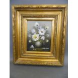 An oil on board, still life with vase of flowers, signed indistinctly, in a good gilt frame, 8" x