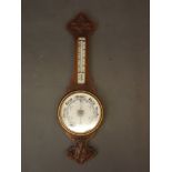 A Victorian carved oak cased aneroid barometer, 32" long