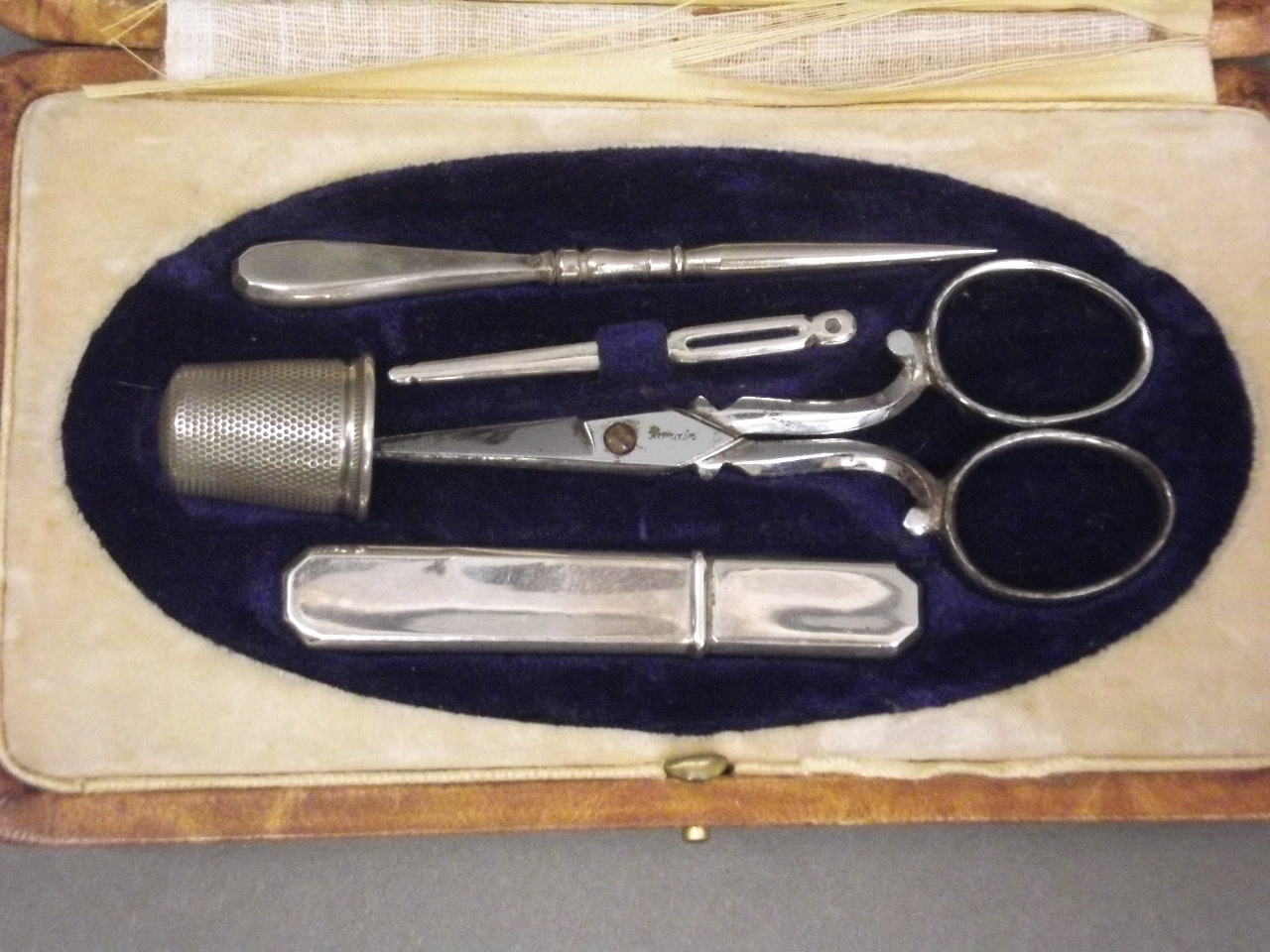 A late C19th manicure set in a leather case, marked 'Maison Charbonnel, Grenoble', 6" x 3" - Image 2 of 3