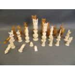 An early C20th Chinese carved ivory chess set, every piece standing on a puzzle ball, king 6½" (