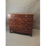 A George III mahogany chest of two over three drawers with ivory escutcheons and original brass oval