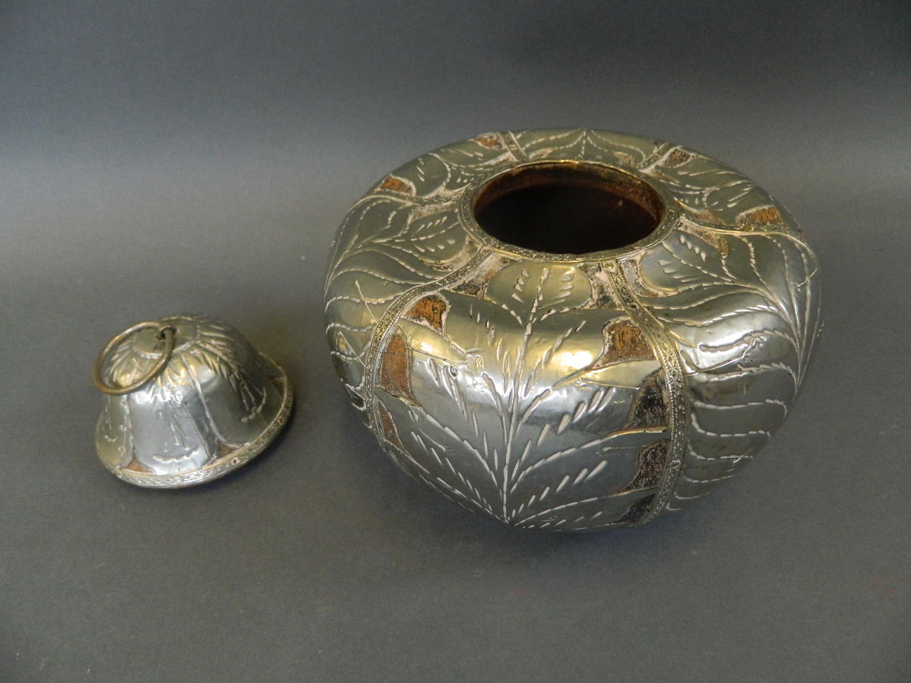A Middle Eastern wooden pot and cover of squat form with white metal pierced and engraved leaf - Image 2 of 3