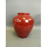 A Chinese flambé glazed earthenware vase, 10" high