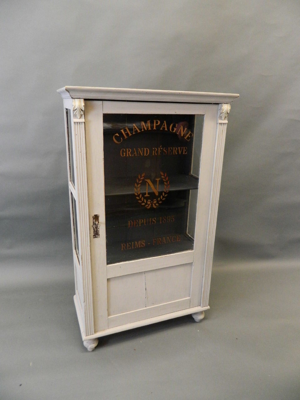 A C19th Continental painted pine display cabinet with decorative sign work to glass, 13" x 25" x 43"