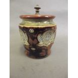 A Royal Doulton stoneware tobacco jar with dimpled sides, impressed with Art Nouveau leaf designs,