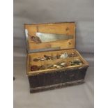 A C19th pine tool chest with filled compartments containing old saws, planes, tools etc, 37" x 21" x