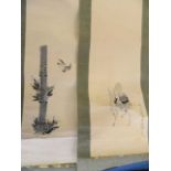 A pair of Chinese painted scrolls depicting Yue Lao riding a deer, and a bird flying near bamboo,