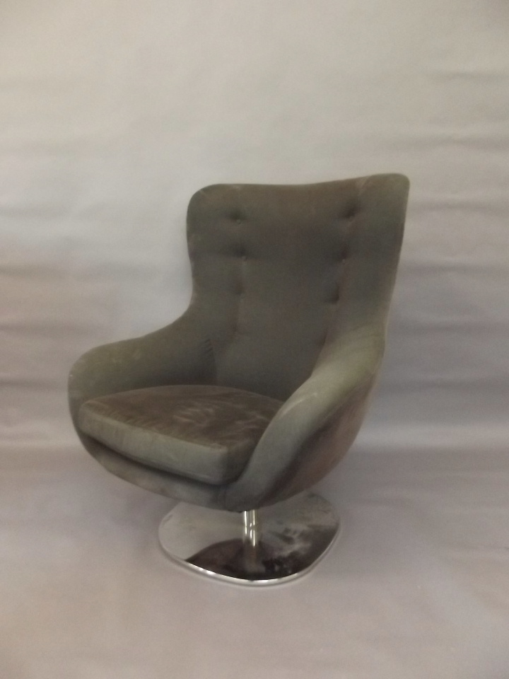 A late C20th swivel easy chair on a chrome platform base