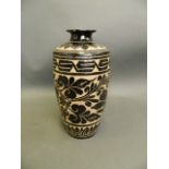 A Chinese black ground pottery vase in the Cizhou kiln style with chased floral decoration, 10" high