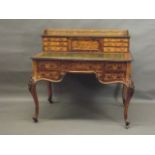 A C19th figured walnut desk with fine boxwood inlaid decoration of scrolls, exotic birds and