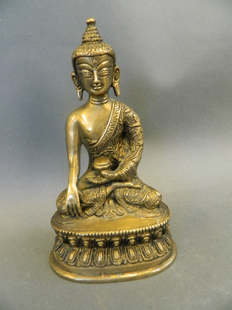 A Chinese bronze figure of Buddha seated in meditation, 7" high