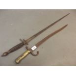 A late C18th/early C19th Cullum, King's Dragoon Guard's sword, and a C19th French bayonet (AF)