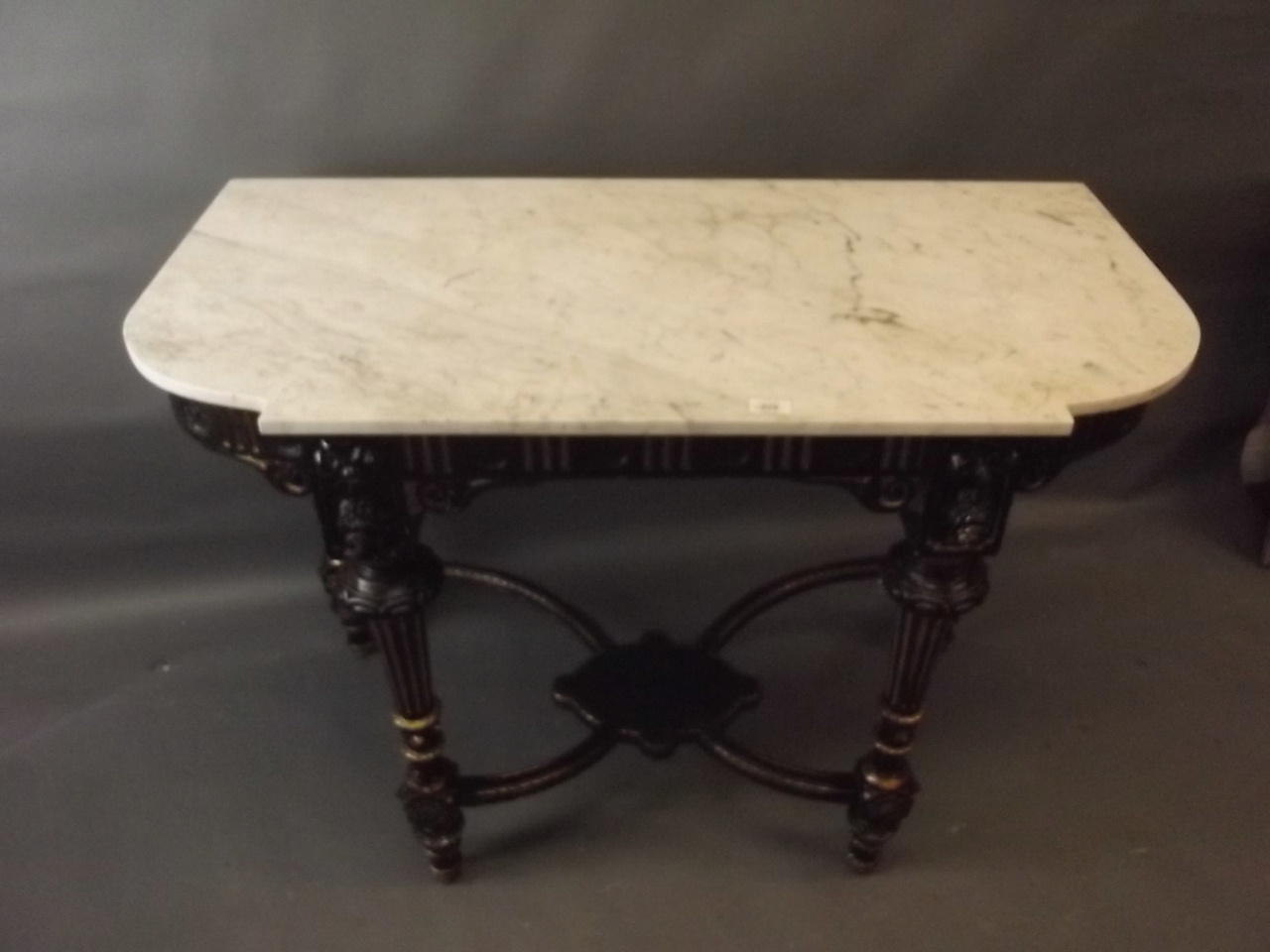 A C19th ebonised and parcel gilt console table with crossed stretchers and undertier, and marble - Image 3 of 3