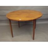 A mid C20th teak circular dining table with fold-out leaf, 44" diameter