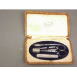 A late C19th manicure set in a leather case, marked 'Maison Charbonnel, Grenoble', 6" x 3"