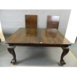 A Victorian mahogany draw leaf dining table with two extra leaves, raised on carved cabriole