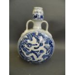 A Chinese blue and white porcelain moonflask with twin handles and incised dragon decoration, 6