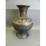A large Islamic bronze vase with engraved foliate decoration, 20½" high