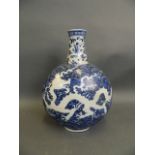 A Chinese blue and white porcelain moonflask with incised dragon decoration, seal mark to base, 12½"