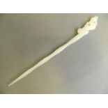 A Chinese white jade hairpin with carved dragon decoration to handle, 8½" long