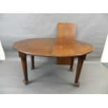 A late Victorian oval shaped wind-out dining table with one extra leaf, raised on tapering
