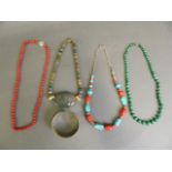 A collection of semi-precious stone necklaces to include malachite, coral, turquoise, and jade,