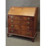 A George III figured mahogany fall front bureau with fitted interior over four drawers, raised on