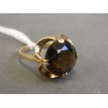 A 9ct gold lady's dress ring set with a circle cut smokey quartz, size M