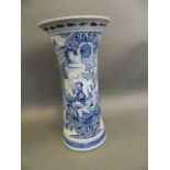 A Delft pottery blue and white vase with flared neck decorated with a woman harvester, 11½" high