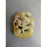 A Chinese green jade pendant with carved archaic decorated of an entwined dragon and phoenix, 2"