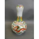 A Chinese Wucai enamel porcelain garlic head shaped vase decorated with dragons chasing the