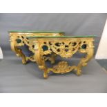 A pair of giltwood console tables with serpentine shaped and carved painted tops, 55" x 18" x 33"