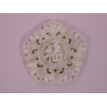 A Chinese white jade pendant with carved decoration of five bats, 2" diameter