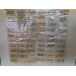 A large quantity of Chinese facsimile (replica) bank notes, in two wall hanging wallets, largest