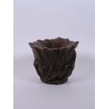 A Chinese faux horn libation cup carved in the form of a lotus flower, seal mark to base, 4" high