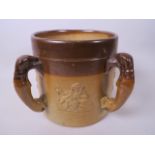 A large C19th salt glazed stoneware tankard with four greyhound handles and embossed figure and tree